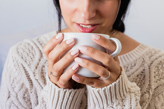 Portrait of a beautiful woman drinking a cup of hot coffee