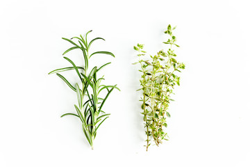 Green branchs of rosemary and thyme isolated on a white background. Flat lay. Top view