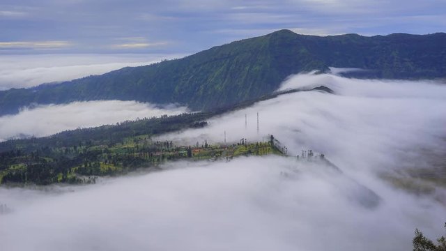 4K Timelapse of rolling clooud over mount bromo. Tilt Down effect
