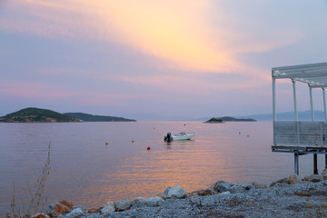 Sunset over the sea with a boat centre