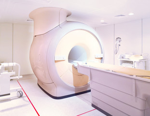 MRI or Magnetic resonance imaging scanner machine in Hospital isolated on  blurred MRI Room...