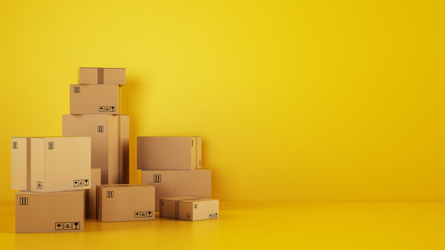 Pile of cardboard boxes on the floor on a yellow background