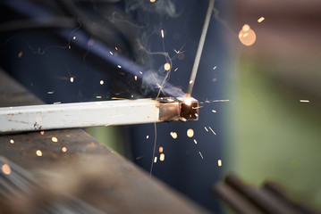 Welding work. Sparks fly in different directions.