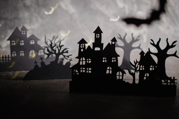 Fototapeta na wymiar Halloween night background. Paper art. Abandoned village in a dark misty forest