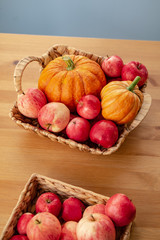 Still life with pumpkins and apples in the basket.  Space for text. Happy Thanksgiving background.