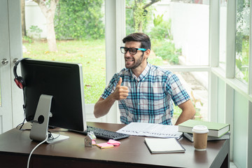 Fototapeta premium Casual young caucasian businessman at his desk in winning concept.
