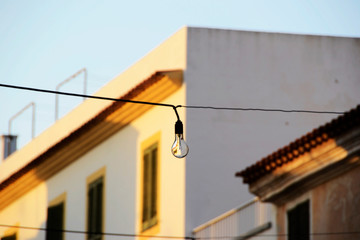 Fototapeta na wymiar Light bulb in the street with the sunset