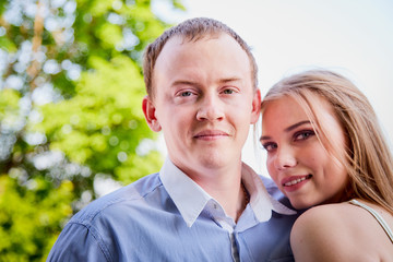 Young man and woman couple walk in the park. Spring or summer love story. Young happy family
