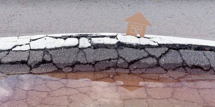Destroyed by disaster houses on cracked road possitive reflection insurance concept
