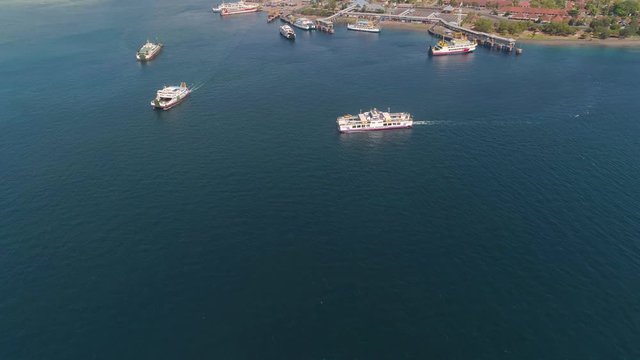 Aerial view ferry port gilimanuk with ferry boats, vehicles. Ferries transport vehicles and passengers in port. Port for departure from Bali to the island of Java.