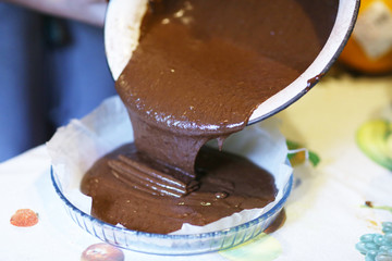 chokolate dough for cake in cooking process with mixer in bowl