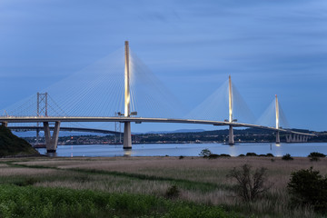 View of a modern motorway suspension bridge at twilight. North Queensferry, Scotland, UK.