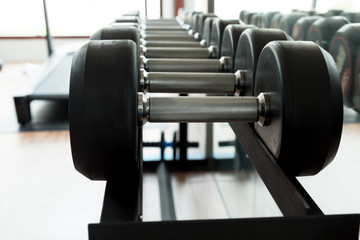 Dumbbells in fitness gym.Selective focus.
