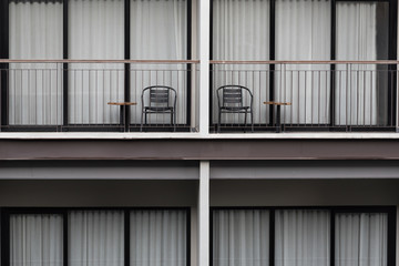 Hotel terrace and table with chair.Door and window of modern condominium.View exterior of high building in the city.