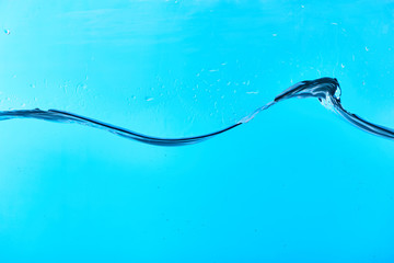 wavy fresh water on blue background with drops
