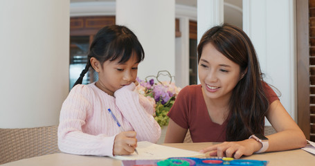 Woman teaching little girls drawing