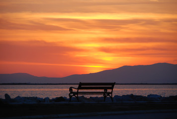 Fototapeta na wymiar Empty bench overlooking the sunset of izmir, Turkey