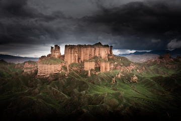 Beautiful Chinese landscape at Binggou Danxia, close to Zhangye. Dramatic dark sky, just before a big thunderstorm. Gansu Province, China.