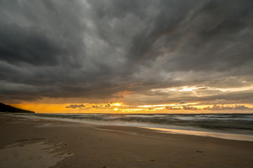 A stormy and dramatic sunrise over the sea. Nature composition. Concept: vacation or weather