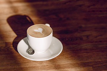 cup of coffee in the light of the sun