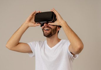 Portrait of excited and amazed young man wearing Virtual Reality headset exploring 3D world