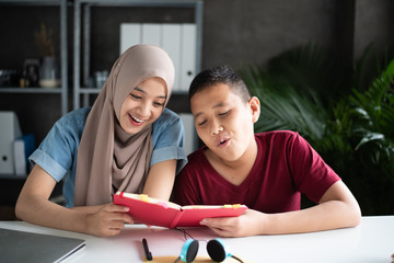 The muslim students reading book at library, doing activity together,with happy feeling