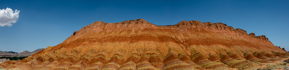 Wide panorama of Zhangye Danxia geological park in Gansu Province, China. Chinese landscape with geological layers. 