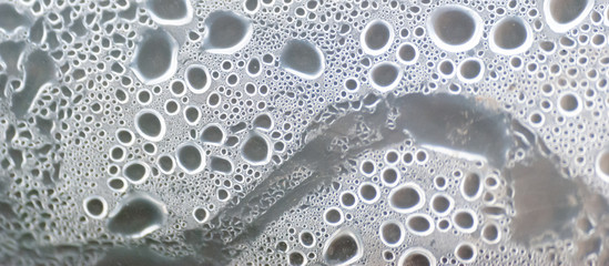 Close up of Water Damp Moisture Condensation Under Striped Plastic Roof. Selective Focus.