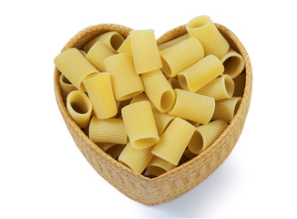 Top view dry pasta penne Italian food in heart shaped bamboo basket isolated white background with clipping path.