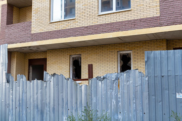 Broken window on an abandoned construction site after developer bankruptcy