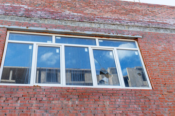 Broken window on an abandoned construction site after developer bankruptcy