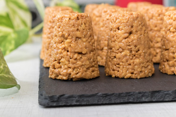 anthill cake close-up on a black stone board background greens