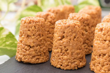 anthill cake close-up on a black stone board background greens