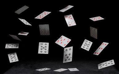 Fototapeta na wymiar playing cards fall on a black table