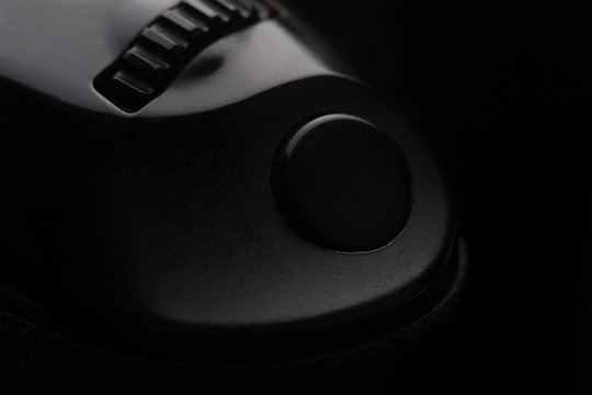 shutter button on a camera shot on a black background 