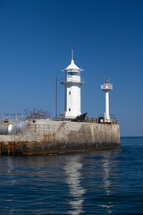 Fototapeta na wymiar Lighthouse on the Yalta embankment. Black Sea.