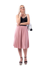 Smart blond hair woman thinking and looking up with finger on chin looking up. Full body isolated on white background.