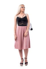 Elegant stylish fashionable blonde woman with glasses walking and looking up. Full body isolated on white background.