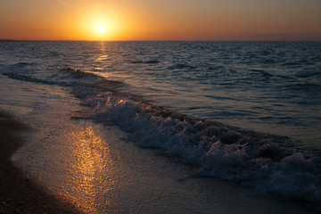 Sunset over the sea horizon.