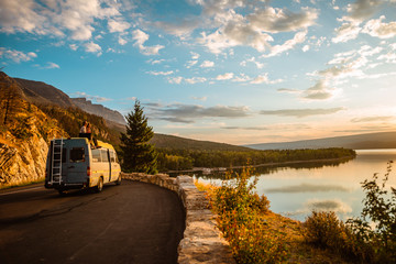 Women enjoying camper van with a view of a lake