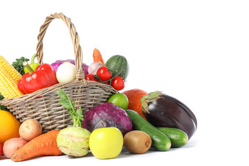 Wicker basket and different vegetables isolated on white background