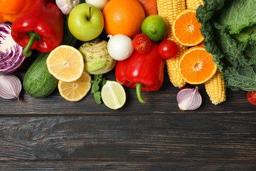 Different vegetables and fruits on wooden background, copy space