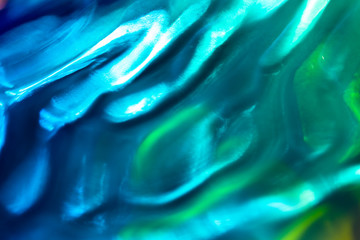 Abstract teal and blue wave pattern background. Colorful water wave background with bright shining surfaces. Summer or spring theme.