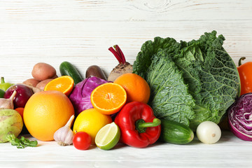 Vegetables and fruits on wooden background, copy space