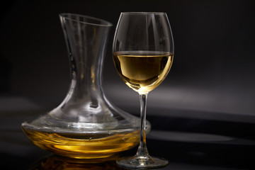 A glass full of wine and wine decanters