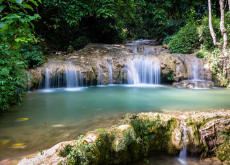 Fototapeta na wymiar Waterfall at Pu Luong, Mai Chau area, Vietnam. Long exposure smooth flow of crystal clear water. 