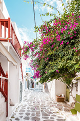 Typical Greek architecture in the white, cobbled alleys of Mykonos town, houses in the old town of Chora with colorful balconies and white churches, Cyclades, Greece