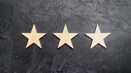 Three stars on a dark background. The concept of rating and evaluation of hotels, restaurants,...