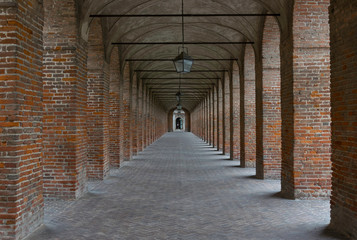 Old alley with brick colunnade and arches