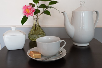 cup of tea and flowers on wooden table